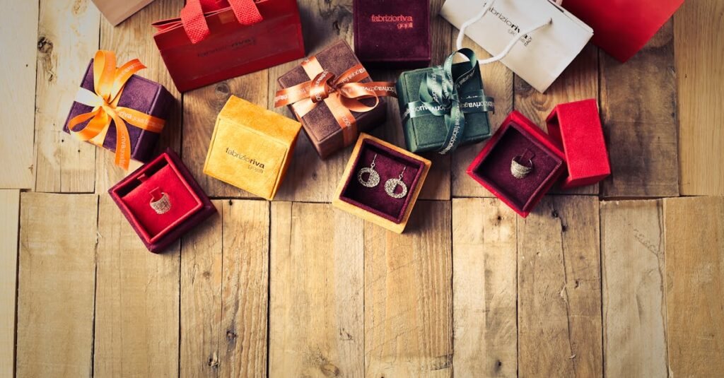 Elegant jewelry gifts with shopping bags on wooden floor, perfect for holiday celebrations.